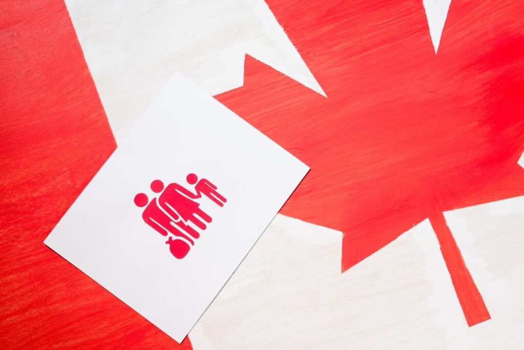 white card with family icon on canadian flag, immigration concept